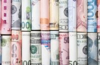 Various international banknotes roll in the world for currency exchange and transfer of forex concept.
